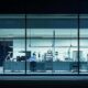 a sleek, modern pharmaceutical lab illuminated by bright, sterile lighting showcases advanced quality assurance practices, with large glass windows revealing meticulous technicians conducting robust testing amidst high-tech equipment.