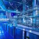 a sleek, modern pharmaceutical manufacturing facility, bathed in soft blue light, showcases cutting-edge machinery and technology that embodies the innovations reshaping third-party manufacturing.