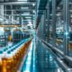 a vibrant pharmaceutical manufacturing facility bustling with activity, showcasing gleaming machinery and meticulously organized production lines under bright, sterile lighting.