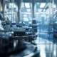a pristine pharmaceutical manufacturing facility bathed in soft, diffused light showcases gleaming stainless steel equipment and meticulously arranged vials, reflecting an atmosphere of precision and innovation.