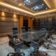 a modern conference room in hyderabad, featuring a sleek glass table surrounded by attentive business professionals discussing strategic plans for succeeding in the pcd pharma franchise market, illuminated by bright, focused led lighting.