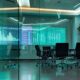 a sleek, modern pharmaceutical office featuring a glass conference room, with vibrant charts and data projections on digital screens, illustrating the dynamic landscape of franchise business strategies in the pharma industry.