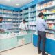 Pharmacy scene in Andhra Pradesh showcasing diverse pharmaceutical products and customer interactions
