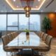 a modern conference room in chennai with a sleek glass table, top-tier technology presentations on display, and professionals engaged in dynamic discussions about selecting and succeeding with pcd pharma franchises.