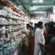 Pharmacy in Uttar Pradesh with diverse customers and pharmacists, highlighting community healthcare