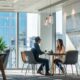 a dynamic office environment showcasing a confident entrepreneur engaging in a strategic discussion with a consultant about launching a successful pharma franchise, highlighted by modern décor and industry-specific visual aids.